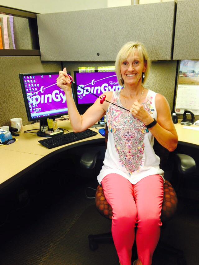 Team Kansas City - Carol Ortloff shows off her GUNS and SpinGym at work!